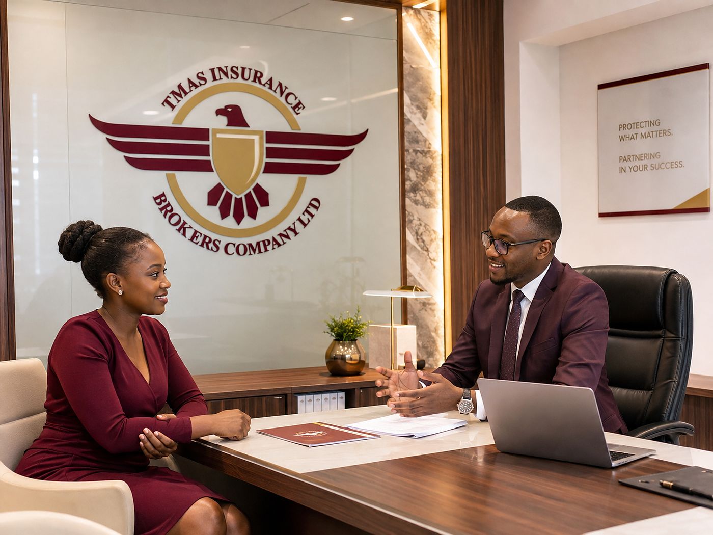 An adviser going through cover with a client across a desk at the TMAS office
